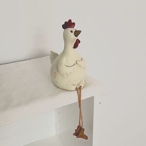 Cute sitting Hen with dangling legs
